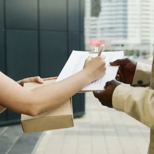 An outdoor scene of a package being delivered and a receipt being signed.